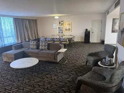 a living room with a couch and chairs and a table at DoubleTree by Hilton Cherry Hill Philadelphia in Cherry Hill
