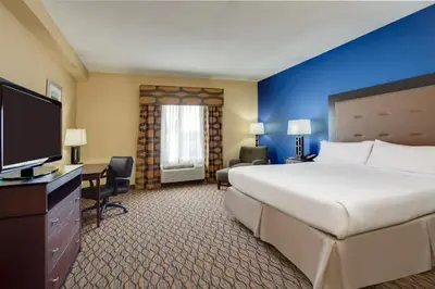 a hotel room with a large bed and a flat screen tv at Holiday Inn Express Tower Center New Brunswick by IHG in East Brunswick