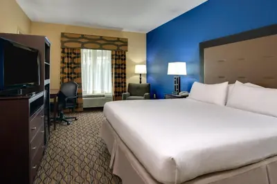 a hotel room with a large bed and a flat screen tv at Holiday Inn Express Tower Center New Brunswick by IHG in East Brunswick