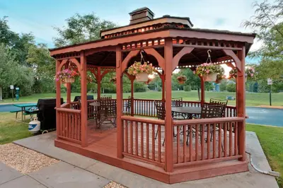 a wooden gazebo with a table in a park at Sonesta Simply Suites Nanuet in Nanuet