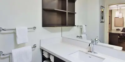 a white bathroom with a sink and a mirror at Sonesta Simply Suites Nanuet in Nanuet