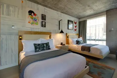 a hotel room with two beds and a window at Hotel 50 Bowery, part of JdV by Hyatt in New York