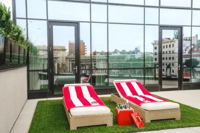 two red and white chairs sitting on top of a building at Hotel 50 Bowery, part of JdV by Hyatt in New York