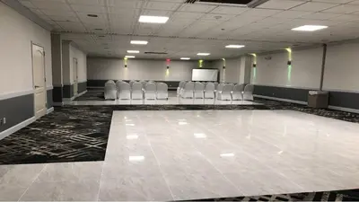 an empty room with chairs and a podium in a room at Holiday Inn Hazlet by IHG in Hazlet