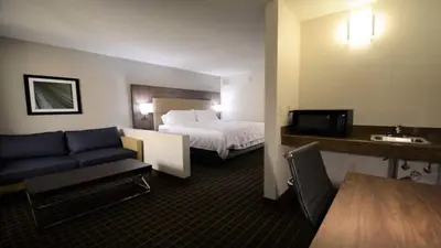 a hotel room with a bed and a couch at Holiday Inn Hazlet by IHG in Hazlet