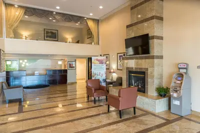 a lobby of a hospital with a fireplace at Holiday Inn Hazlet by IHG in Hazlet