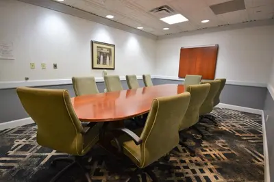 a conference room with a wooden table and chairs at Holiday Inn Hazlet by IHG in Hazlet