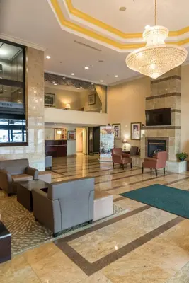a lobby of a hotel with couches and a fireplace at Holiday Inn Hazlet by IHG in Hazlet