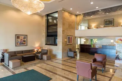 a lobby with couches and chairs in a building at Holiday Inn Hazlet by IHG in Hazlet