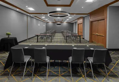a conference room with a large table and chairs at Holiday Inn Hasbrouck Heights-Meadowlands by IHG in Hasbrouck Heights