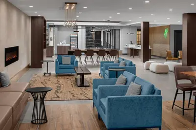 a lobby with blue couches and a living room at Holiday Inn Hasbrouck Heights-Meadowlands by IHG in Hasbrouck Heights