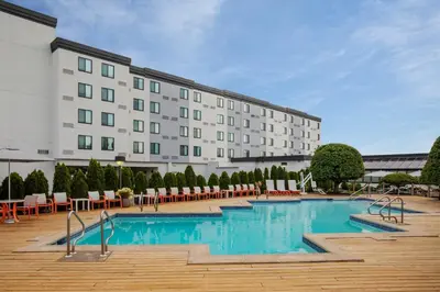a hotel with a swimming pool in front of a building at Holiday Inn Hasbrouck Heights-Meadowlands by IHG in Hasbrouck Heights