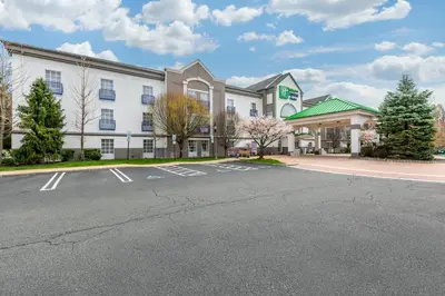 an empty parking lot in front of a hotel at Holiday Inn Express Mount Arlington by IHG in Mount Arlington