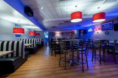 a dining room with tables and chairs in a restaurant at Red Roof PLUS Woodbridge - Carteret in Carteret