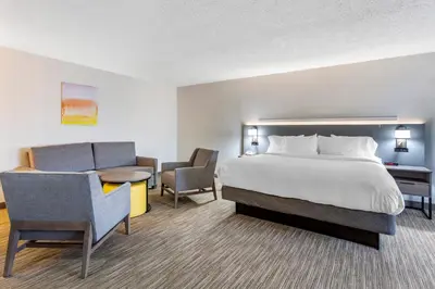 a hotel room with a bed and a chair at Comfort Inn Paramus - Hackensack in Paramus