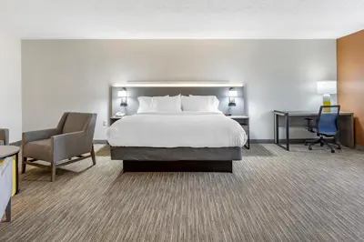 a hotel room with a bed and a desk and a chair at Comfort Inn Paramus - Hackensack in Paramus