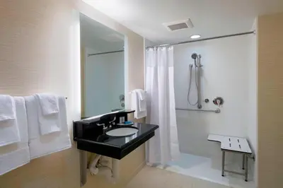 a bathroom with a sink and a shower at Fairfield Inn & Suites by Marriott Paramus in Paramus