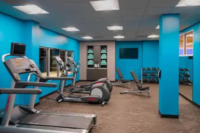a gym with several treadmills and cardio machines at Fairfield Inn & Suites by Marriott Paramus in Paramus