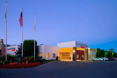 a front view of a building with an american flag at Fairfield Inn & Suites by Marriott Paramus in Paramus