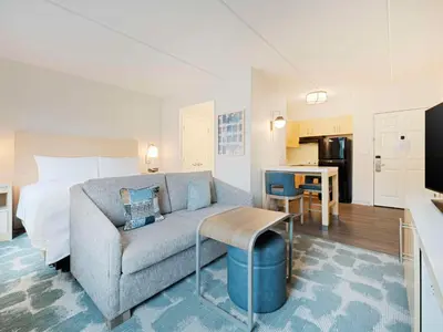 a living room with a couch and a bed and a kitchen at Homewood Suites by Hilton Parsippany-Troy Hills in Parsippany