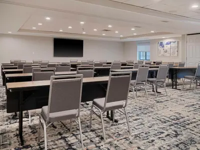 a conference room with a large table and chairs at Homewood Suites by Hilton Parsippany-Troy Hills in Parsippany