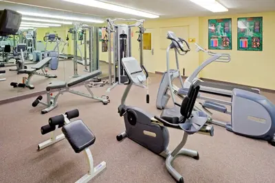 a gym with several treadmills and exercise bikes at Sonesta Simply Suites Parsippany Morris Plains in Morris Plains