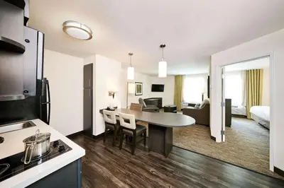 a kitchen and living room with a table in a room at Sonesta Simply Suites Parsippany Morris Plains in Morris Plains