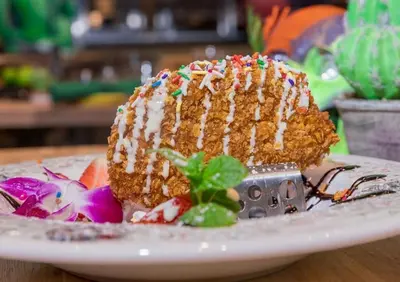 a piece of cake with sprinkles on a plate at Holiday Inn & Suites Parsippany Fairfield by IHG in Parsippany