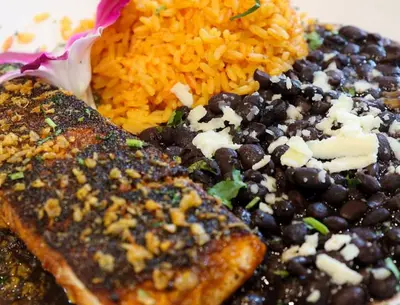 a plate of food with black beans and rice at Holiday Inn & Suites Parsippany Fairfield by IHG in Parsippany