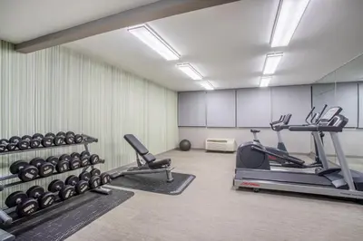 a gym with weights and tread machines in a room at Holiday Inn & Suites Parsippany Fairfield by IHG in Parsippany