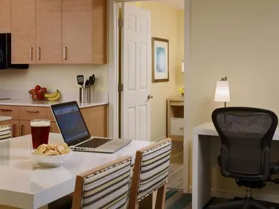 a kitchen with a table with a laptop computer on it at Sonesta ES Suites Somerset in Somerset