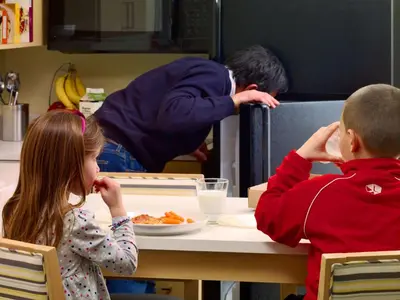a boy and a girl sitting at a table eating food at Sonesta ES Suites Somerset in Somerset