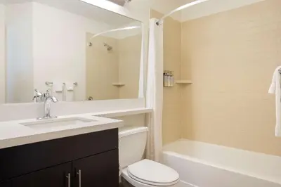 a bathroom with a sink and a toilet and a tub at Sonesta Simply Suites Somerset in Somerset
