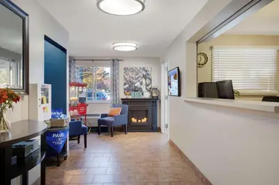 a hallway with a living room with a fireplace at Sonesta Simply Suites Somerset in Somerset