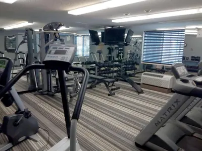 a gym with several treadmills and cardio machines at Sonesta Simply Suites Somerset in Somerset
