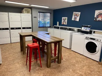 a kitchen with a table and a washing machine at Sonesta Simply Suites Somerset in Somerset