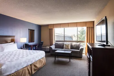 a hotel room with a bed and a couch at Holiday Inn South Plainfield-Piscataway by IHG in South Plainfield