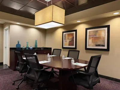 a conference room with a wooden table and chairs at Holiday Inn South Plainfield-Piscataway by IHG in South Plainfield