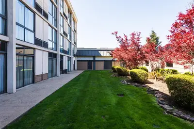 an empty courtyard of a building with a grass yard at Holiday Inn South Plainfield-Piscataway by IHG in South Plainfield