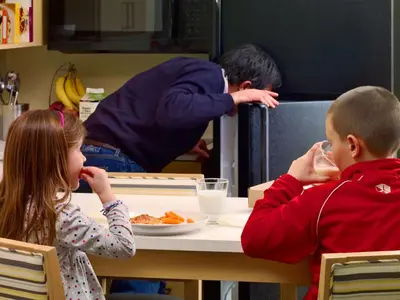 a boy and a girl sitting at a table eating food at Sonesta ES Suites Princeton in Princeton
