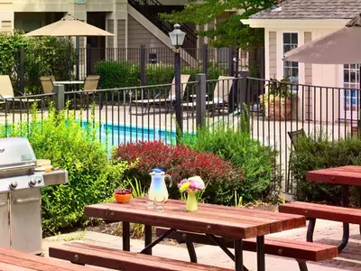 a picnic table with a vase and flowers on it at Sonesta ES Suites Princeton in Princeton