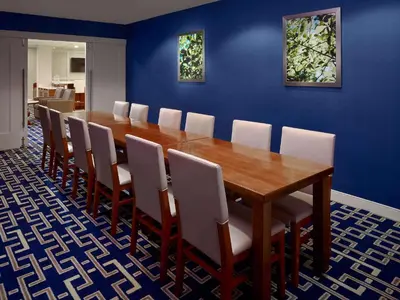 a dining room with a wooden table and chairs at Sonesta ES Suites Princeton in Princeton