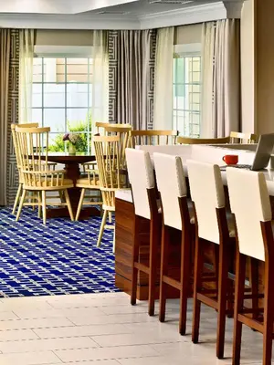 a dining room with a table and chairs at Sonesta ES Suites Princeton in Princeton