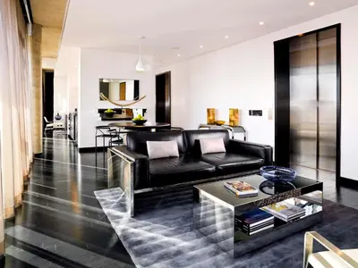 a living room with a black couch and a table at Sixty LES in New York