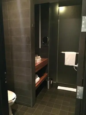 a bathroom with a toilet and a sink and a shower at Sixty LES in New York