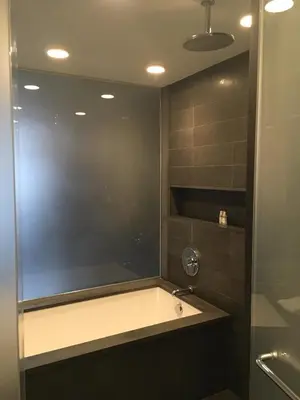 a bathroom with a sink and a glass shower at Sixty LES in New York