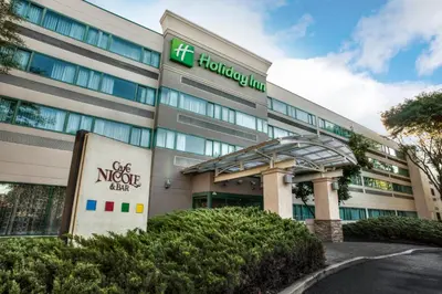 an office building with a sign in front of it at Holiday Inn Princeton by IHG in Princeton