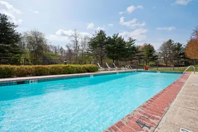 a large swimming pool with chairs in a yard at Holiday Inn Princeton by IHG in Princeton