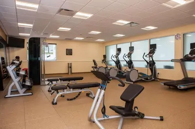 a gym with several treadmills and exercise bikes at Hilton Garden Inn Springfield in Springfield