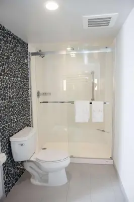 a bathroom with a toilet and a glass shower at Hilton Garden Inn Springfield in Springfield